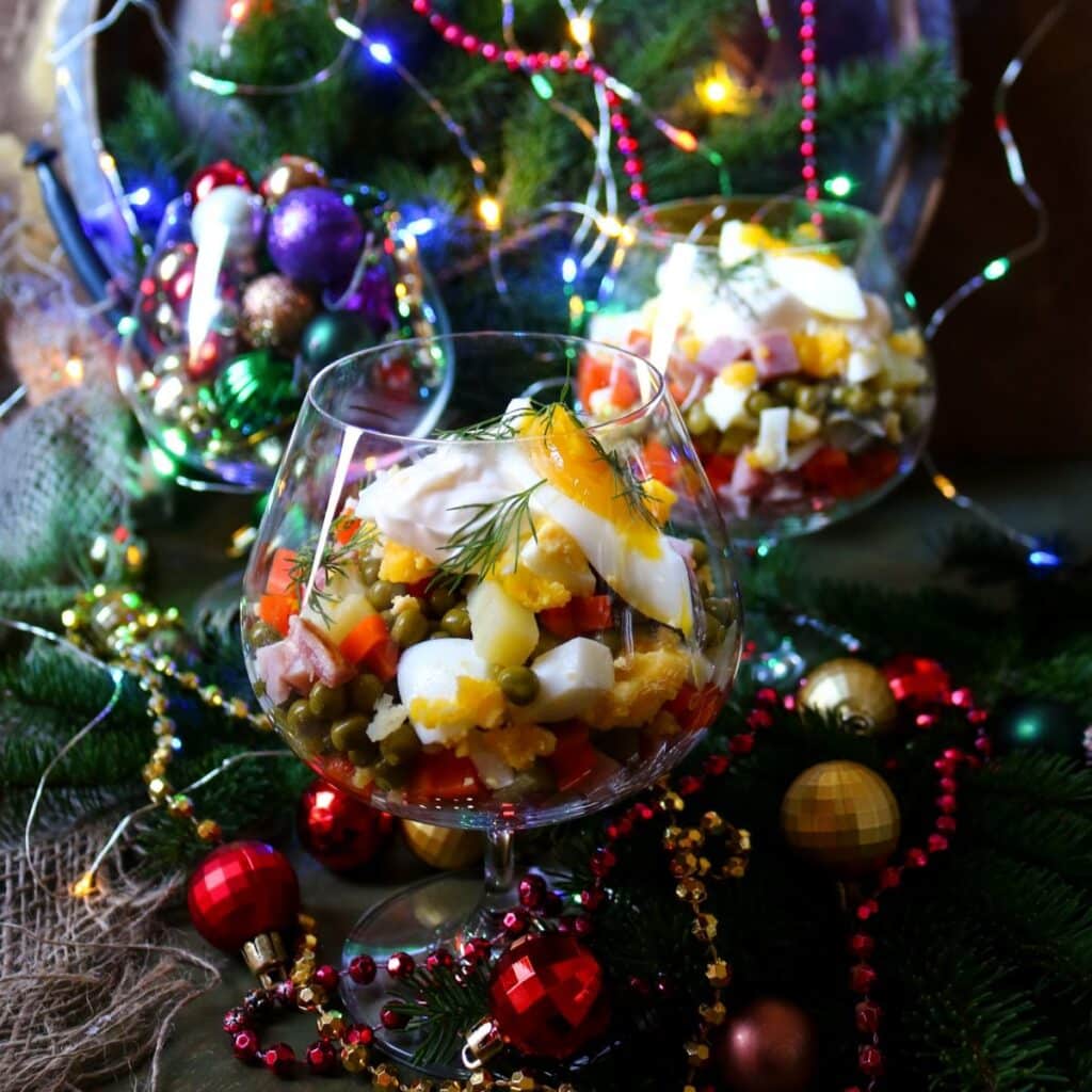Russian Olivier salad made with diced potatoes, vegetables, eggs, and mayonnaise, served as a creamy Eastern European potato salad.