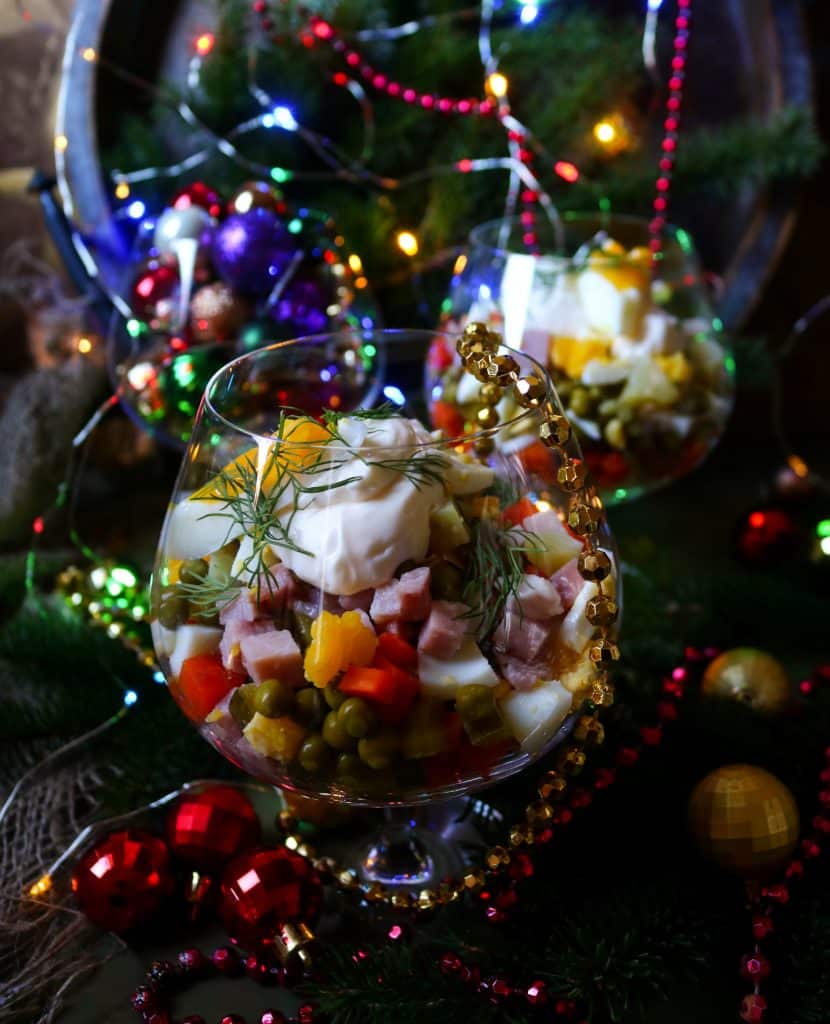 Russian Olivier salad made with diced potatoes, vegetables, eggs, and mayonnaise, served as a creamy Eastern European potato salad.