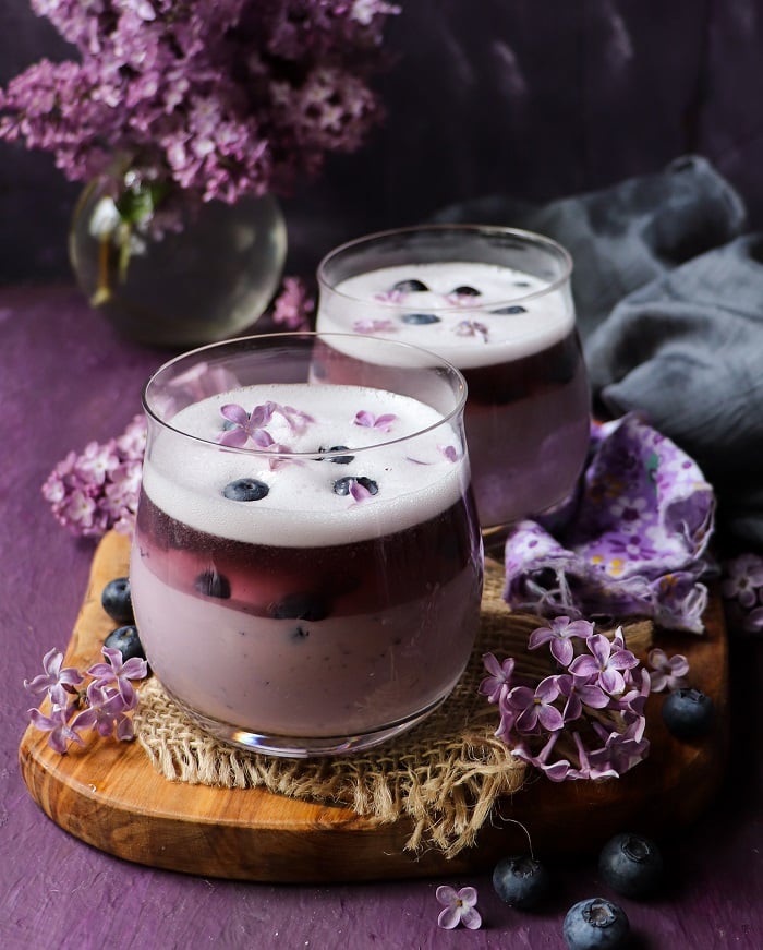 Creamy blueberry lilac panna cotta with aromatic floral presentation.