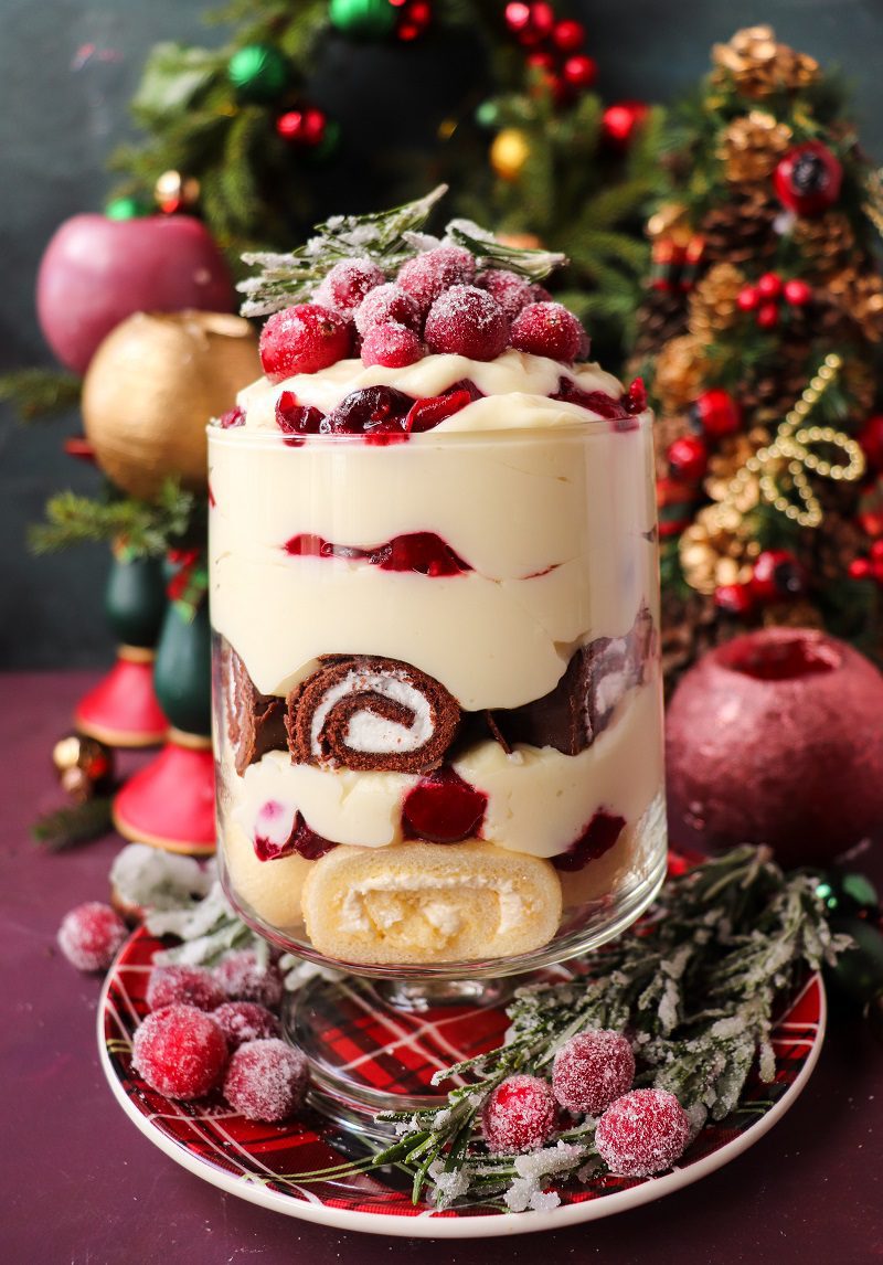 Cranberry Trifle Recipe - Festive Cranberry Holiday Trifle layered with cranberry compote, white chocolate cream, and Swiss roll slices in a glass trifle bowl.