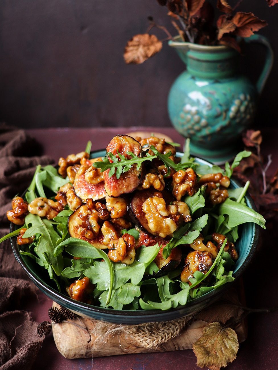 Caramelized fig walnut salad with luscious honey-glazed figs, buttery walnuts, and fresh greens served in a ceramic bowl.