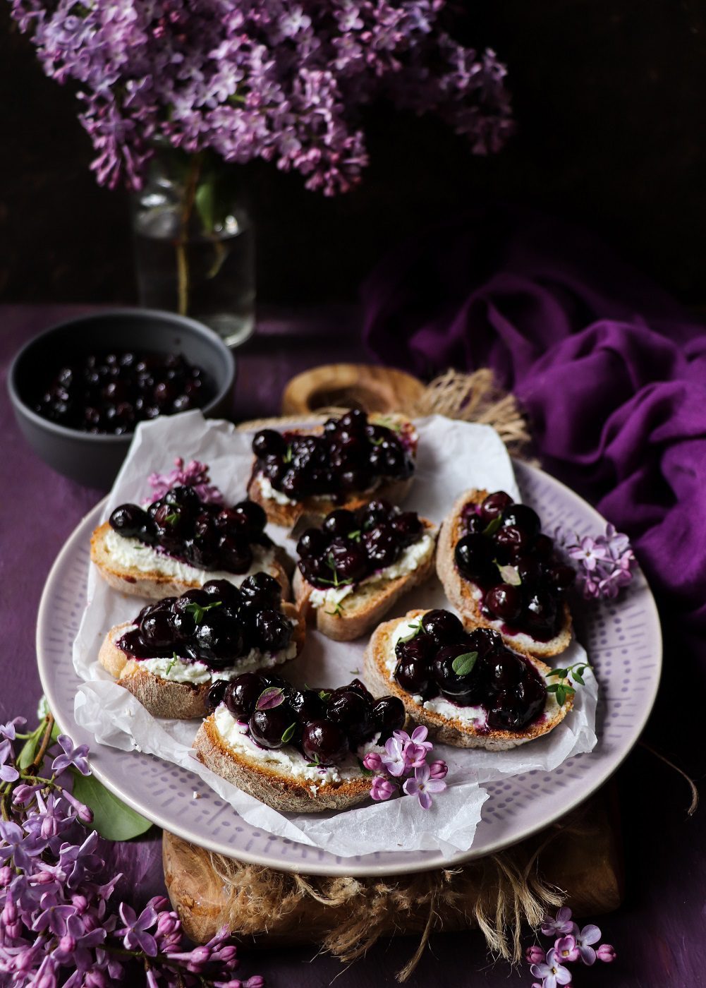 Warm blueberry crostini with goat cheese and fresh thyme.