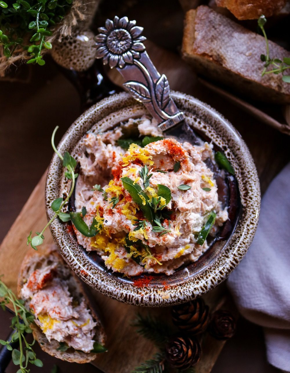 Creamy Tuna Dip with ricotta, lemon zest, fresh herbs, and smoked paprika, served in a rustic bowl with crusty bread on the side.
