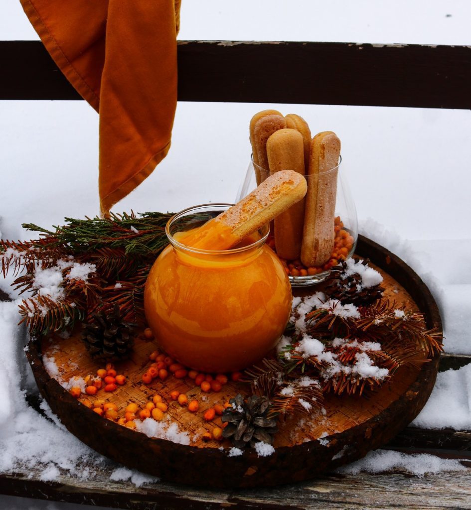 Homemade sea buckthorn curd with glossy texture and cookies for dipping.