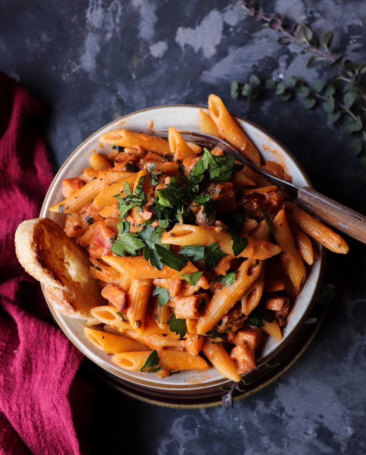 Creamy tomato pasta with ham and herbs served in a bowl, an easy yet elegant classic perfect for romantic dinner recipes.