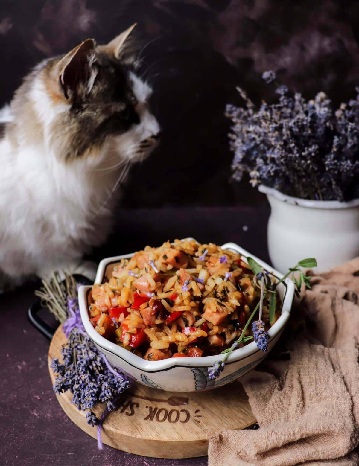Lavender fried rice with ham, peppers, and cashews, showing fluffy texture and herbal garnish
