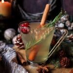 Holiday Spruce Tea in a cozy Christmas mug with honey, cinnamon, and orange slices — a warm, aromatic winter drink.