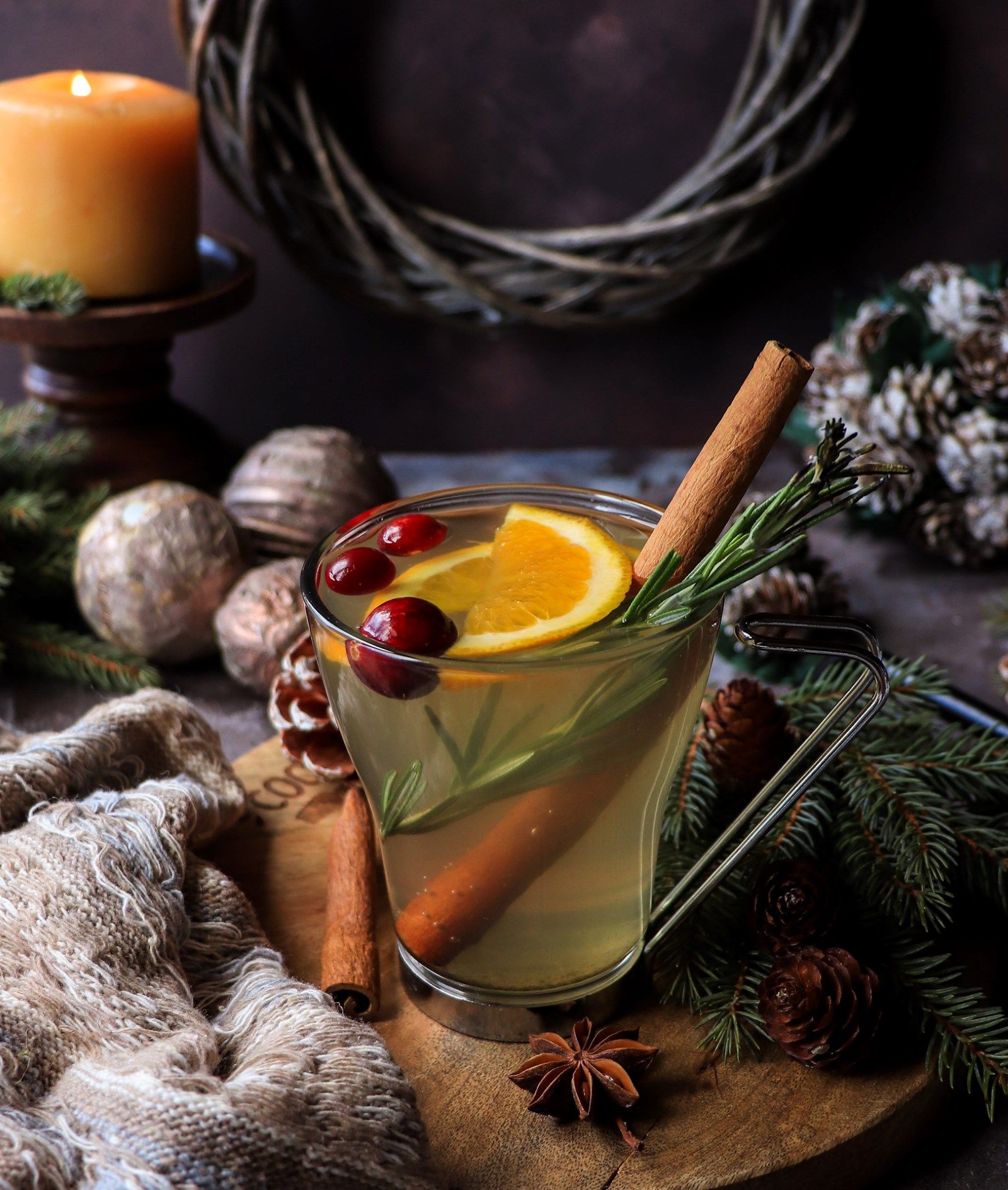 A steaming cup of Holiday Spruce Tea infused with honey, cinnamon, and orange, served with fresh spruce tips — a comforting and festive winter beverage.