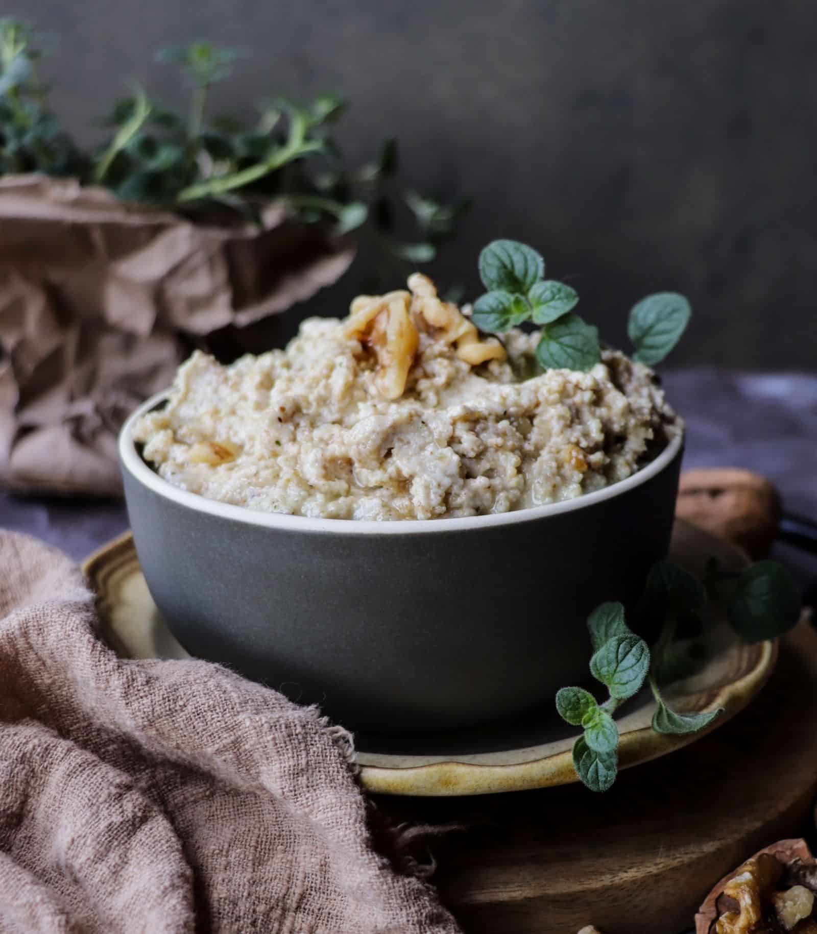 Traditional Ligurian walnut pesto sauce in a bowl, made with ground walnuts, garlic, olive oil, and cheese.