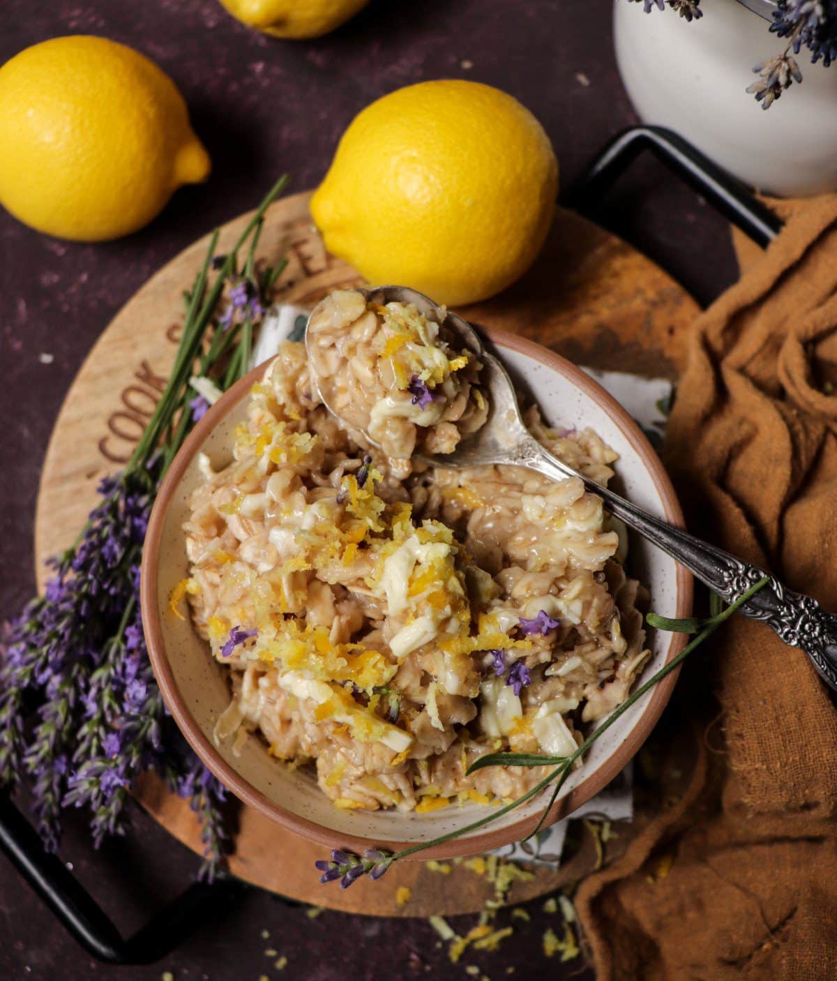 Creamy lavender oatmeal with lemon, white chocolate, and edible lavender flowers.