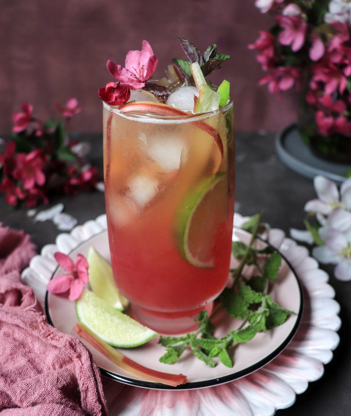 Homemade rhubarb lemonade served over ice with mint and lime.