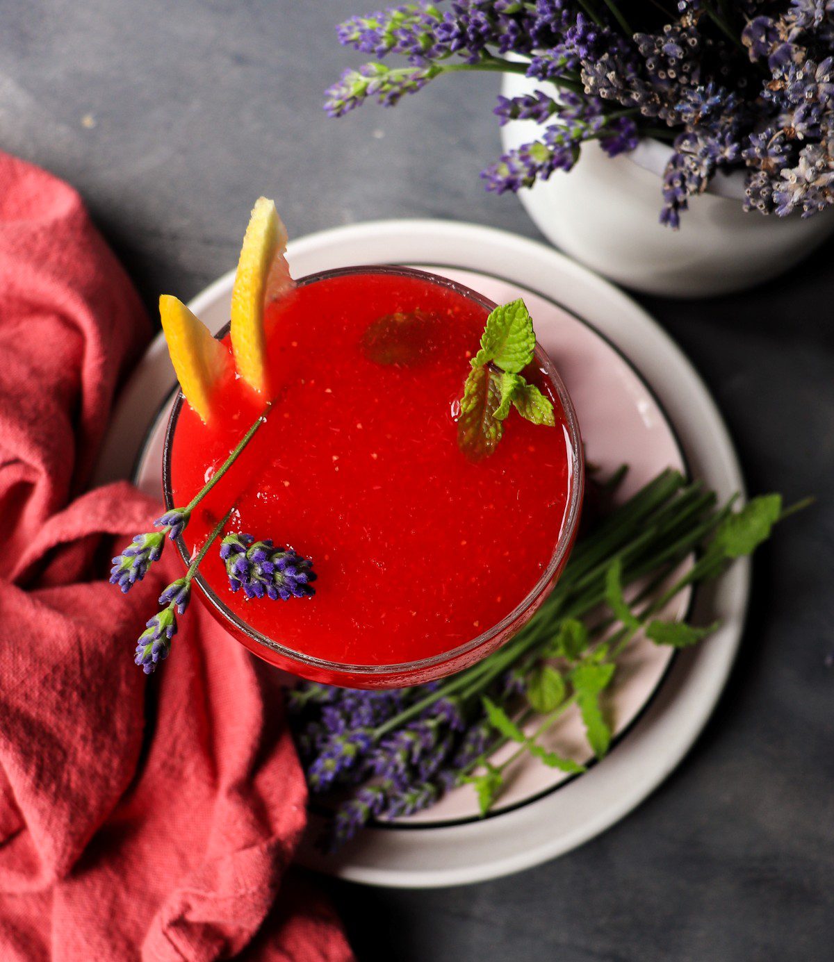 Strawberry lavender frozen daiquiri with rum, fresh berries, and herbs, vibrant fruity and herbal cocktail.