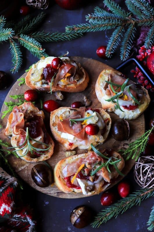 Cranberry Chestnut Brie Crostini with Caramelized Onions and Prosciutto