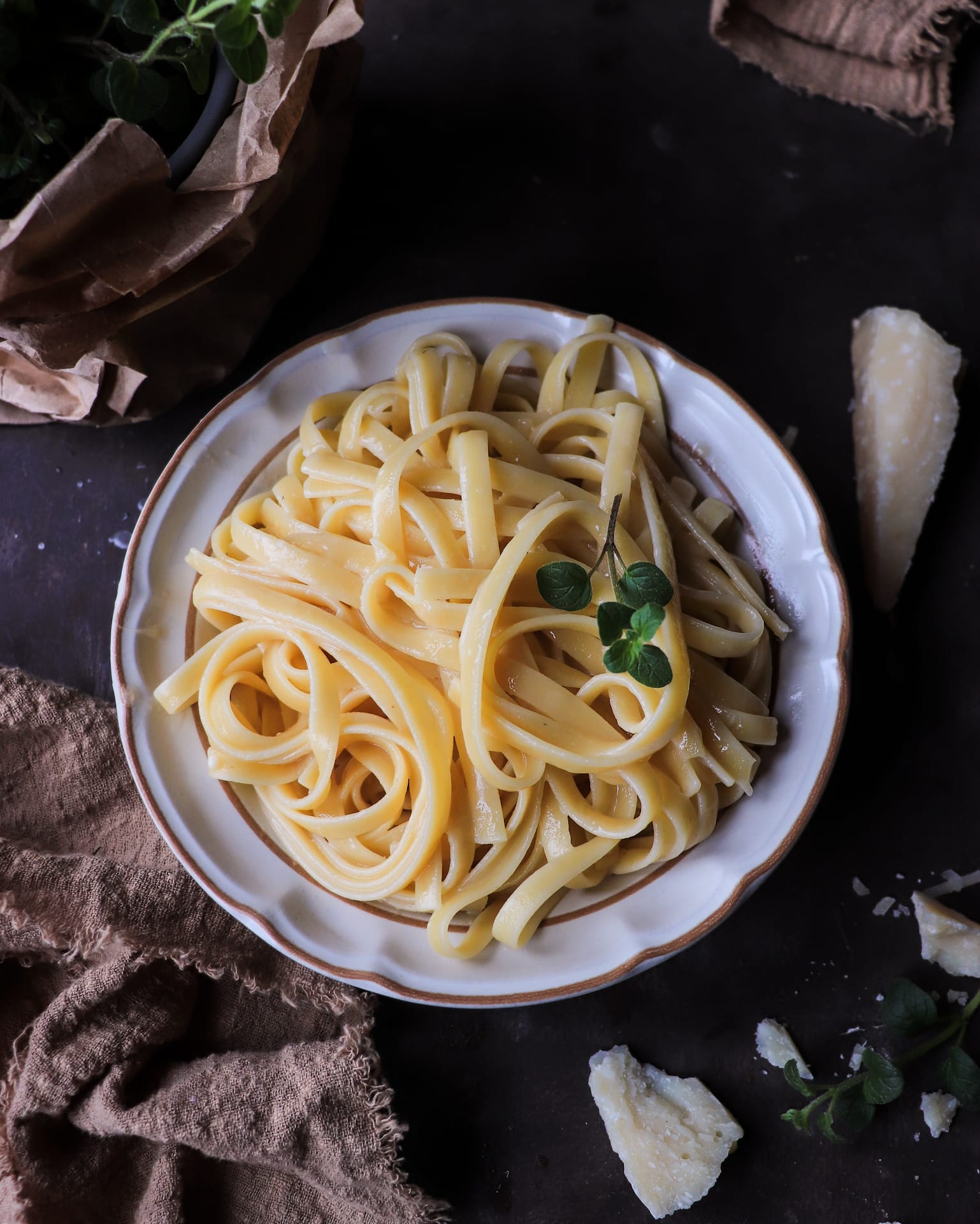 Authentic Italian butter pasta (pasta al burro) made with fettuccine, butter, and Parmigiano Reggiano, served in a white bowl with a fork and finished with a light, glossy coating.