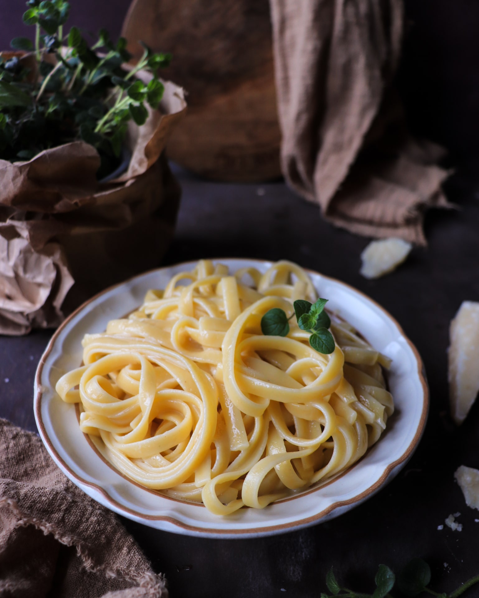 Authentic Italian butter pasta (pasta al burro) made with fettuccine, butter, and Parmigiano Reggiano, served in a white bowl with a fork and finished with a light, glossy coating.