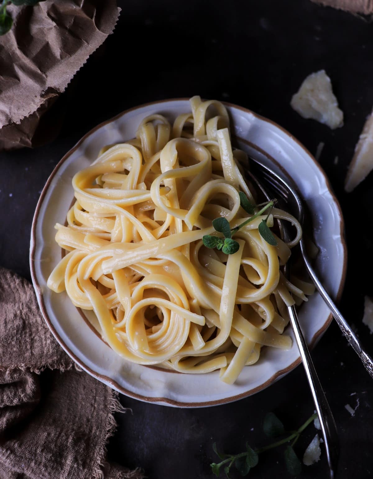 Classic pasta al burro with fettuccine tossed in butter and finely grated Parmigiano Reggiano, showing a smooth, emulsified sauce and silky pasta texture without cream.