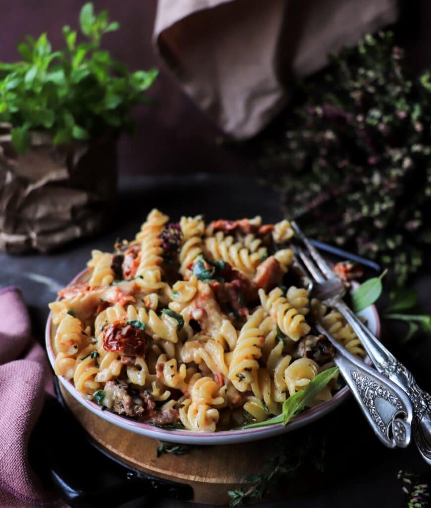 Creamy Marry Me Pasta with sun-dried tomatoes, herbs, and parmesan, served in a shallow bowl with soft natural light.