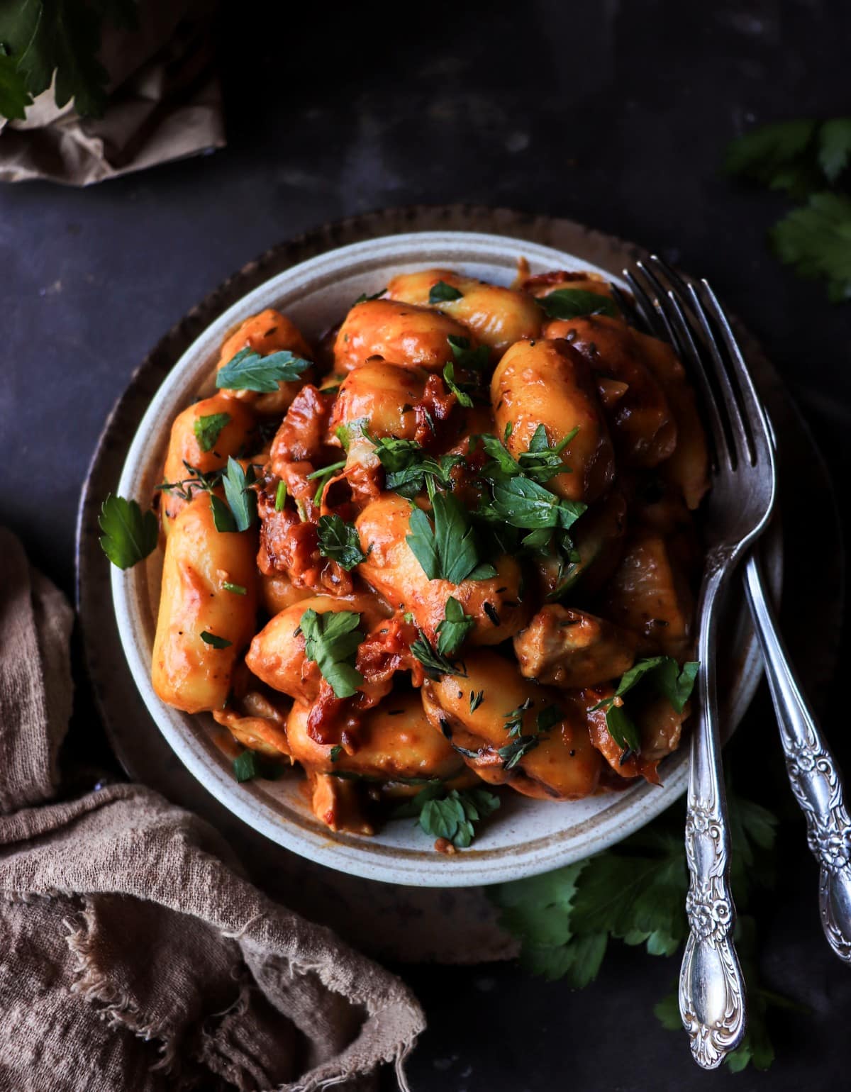 Top-down view of skillet gnocchi with Marry Me chicken sauce, showing pillowy gnocchi tossed in creamy sun-dried tomato sauce with herbs.