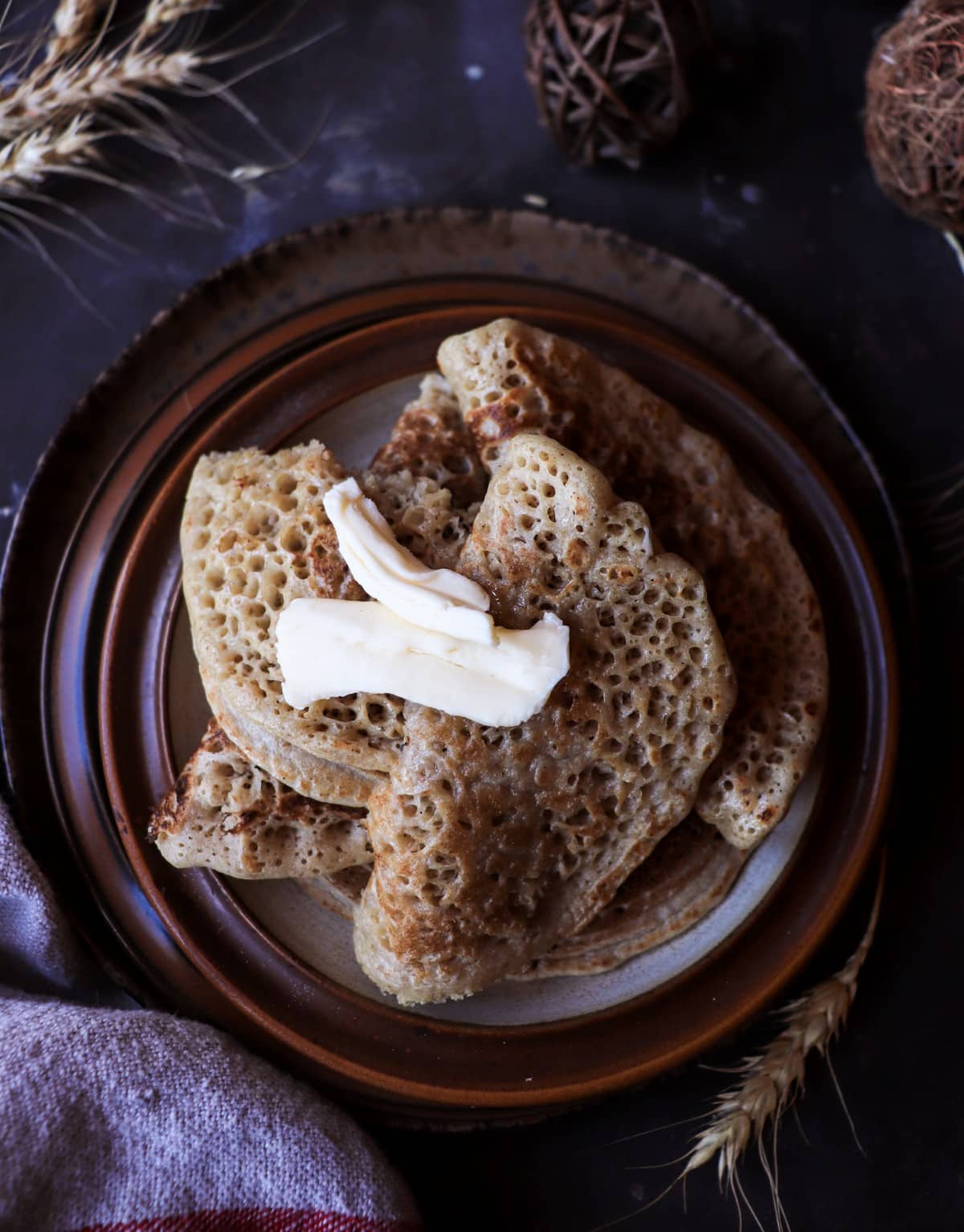 Folded Acadian ployes with slightly deeper browning, illustrating the optional brief flip for added colour.