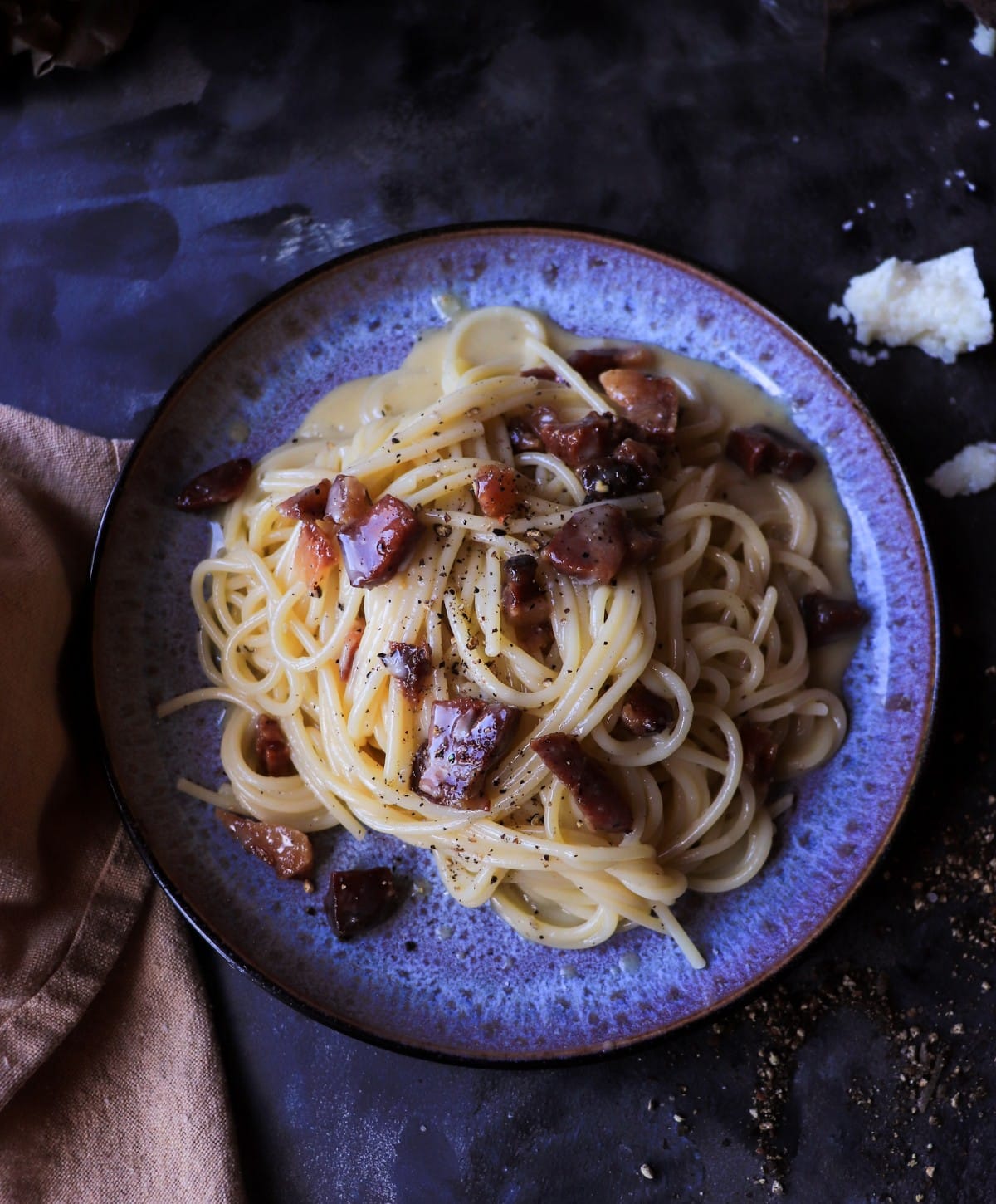 Classic spaghetti carbonara with glossy strands of pasta coated in a silky egg yolk and Pecorino Romano sauce, finished with black pepper.