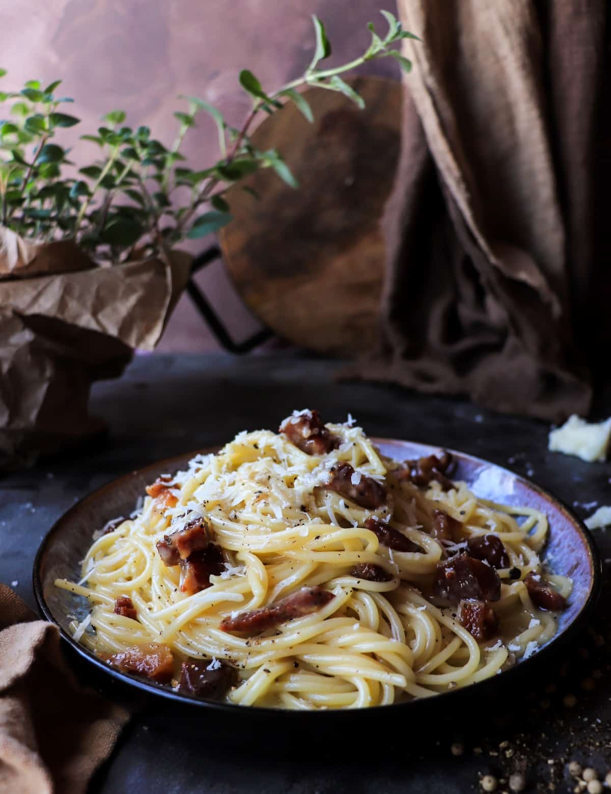 Plated spaghetti carbonara served in a shallow bowl, showing the creamy texture of the sauce and evenly coated pasta strands.