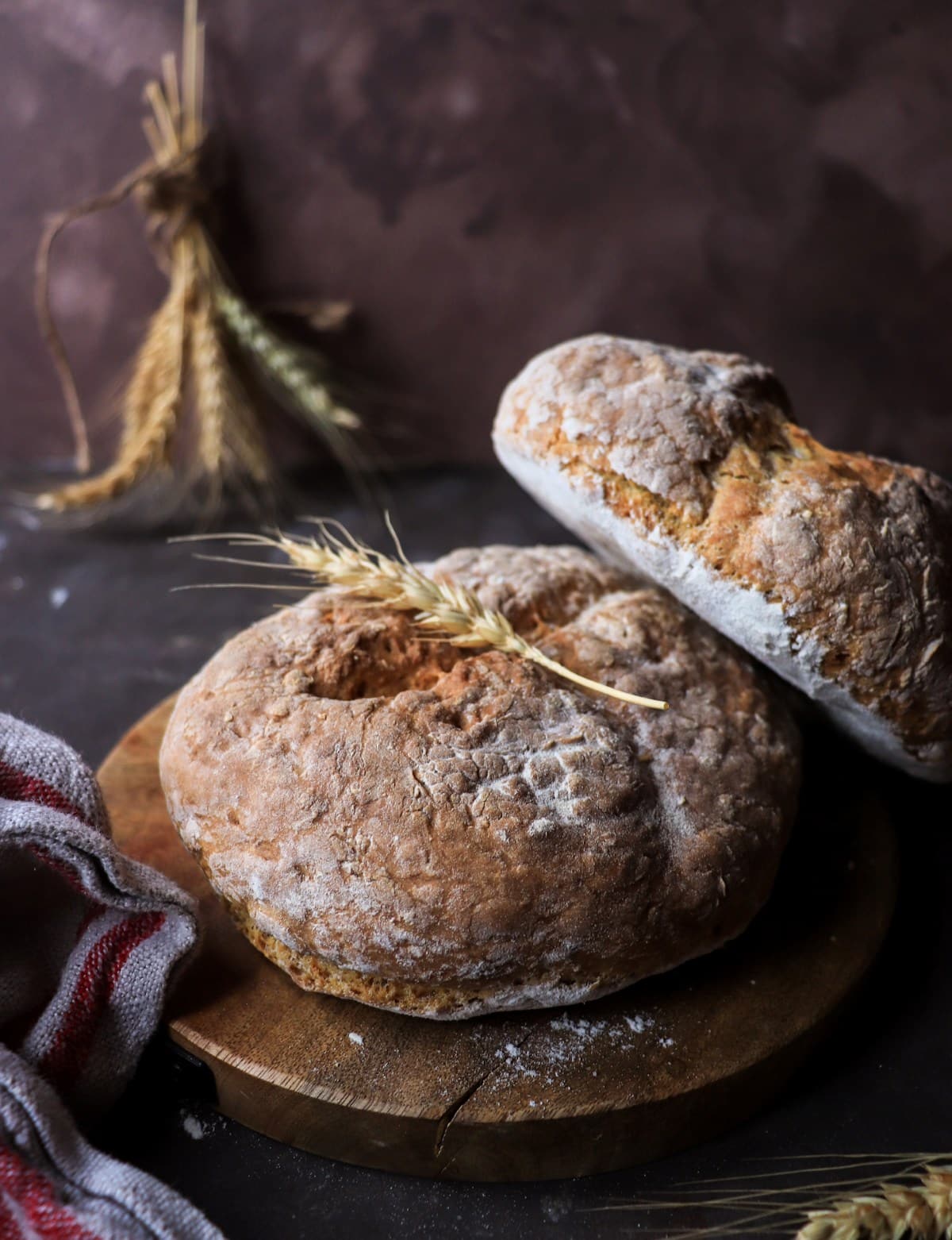 Two small loaves of Irish soda bread with a rustic flour-dusted crust, baked until golden.