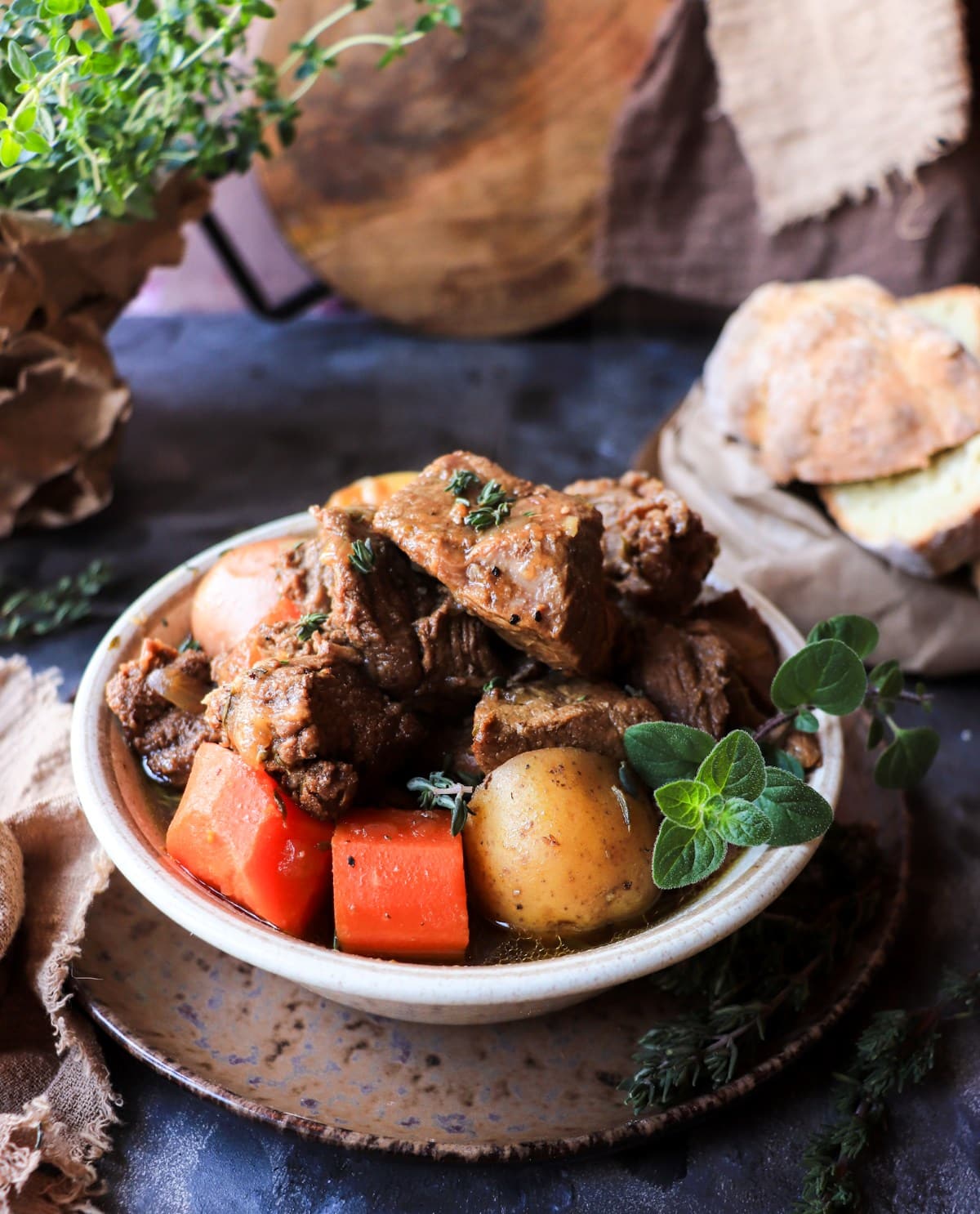 ALT: Traditional Irish stew with Guinness served in a rustic bowl with tender beef, baby potatoes, carrots, and fresh thyme.