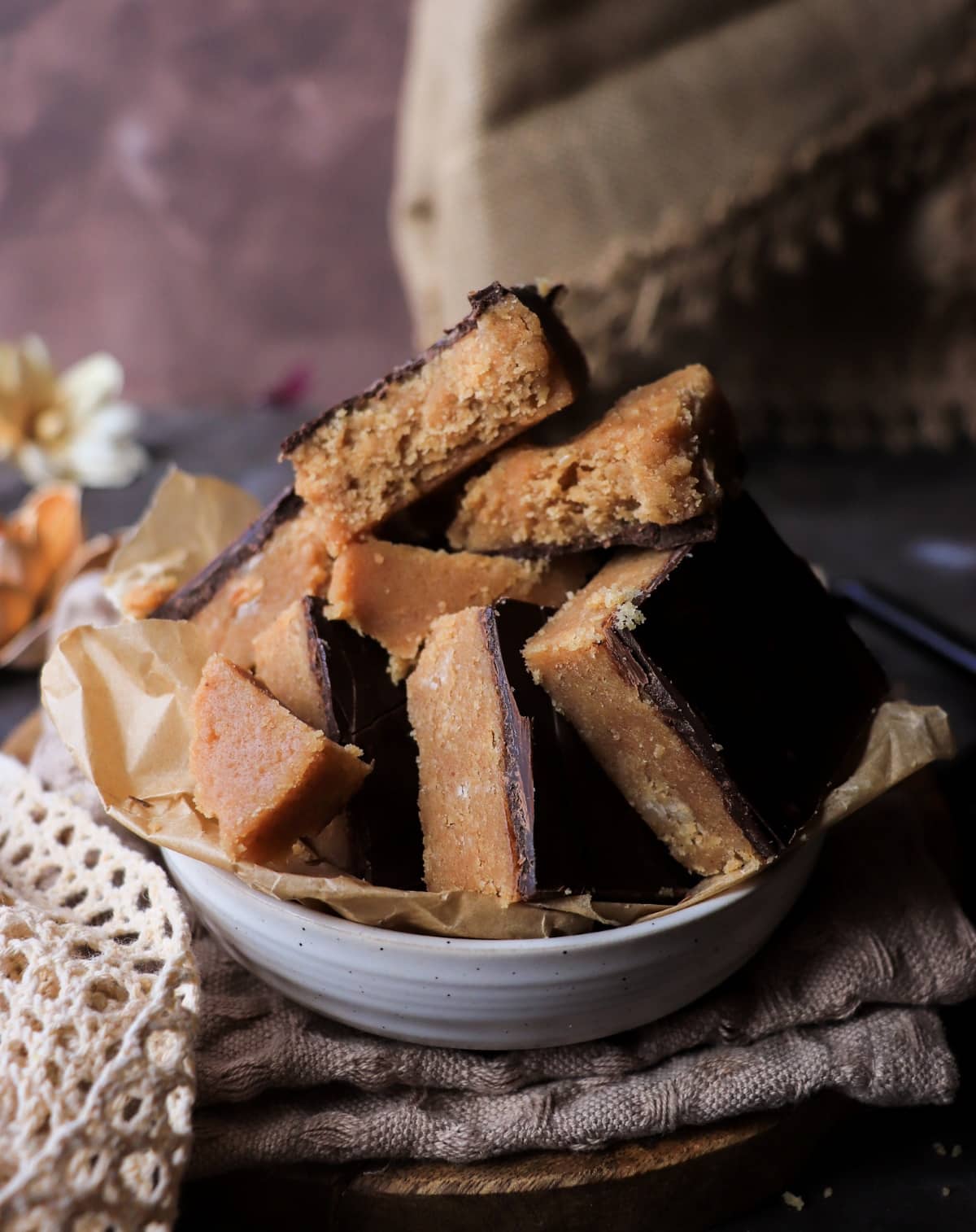 Homemade halva recipe with peanut base and chocolate glaze, sliced pieces.