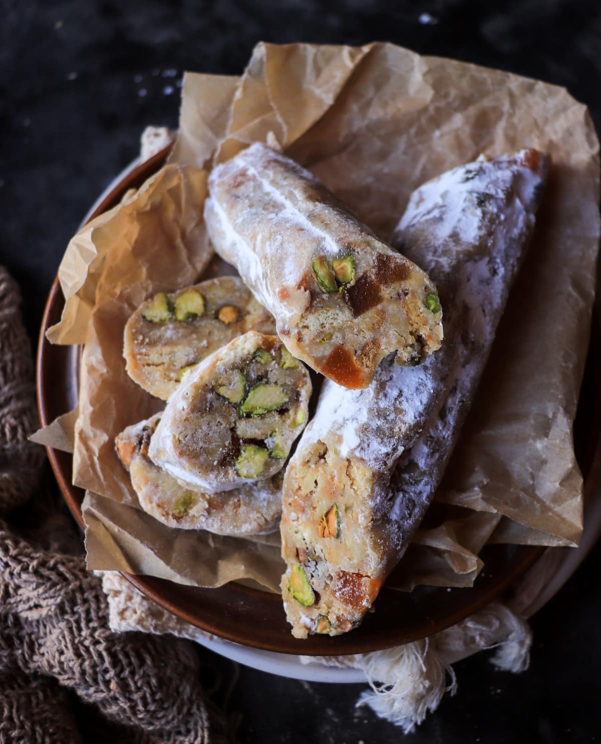 no-bake white chocolate salami dessert with biscuits pistachios and apricots