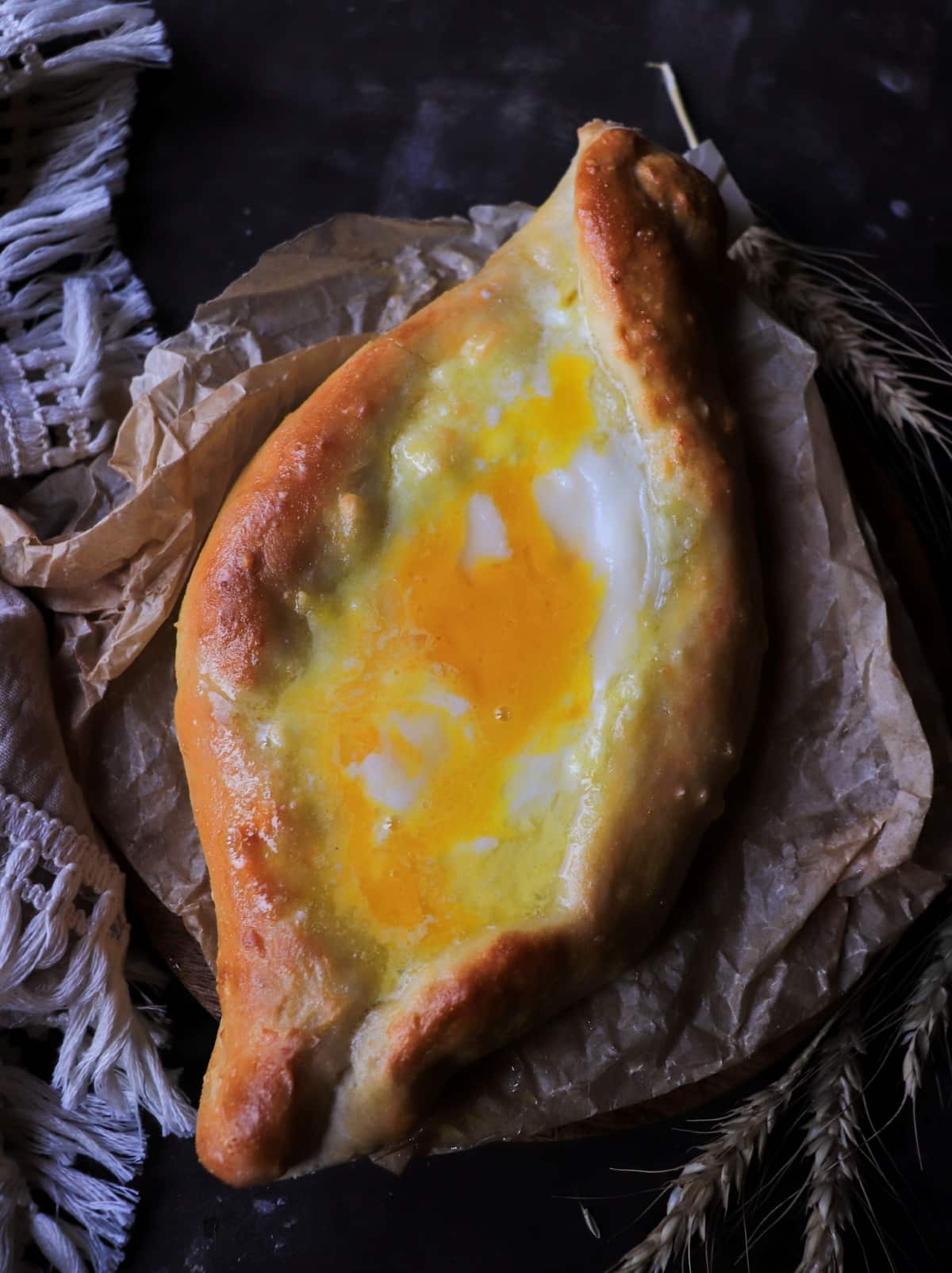 Adjarian khachapuri with runny egg yolk and melted cheese