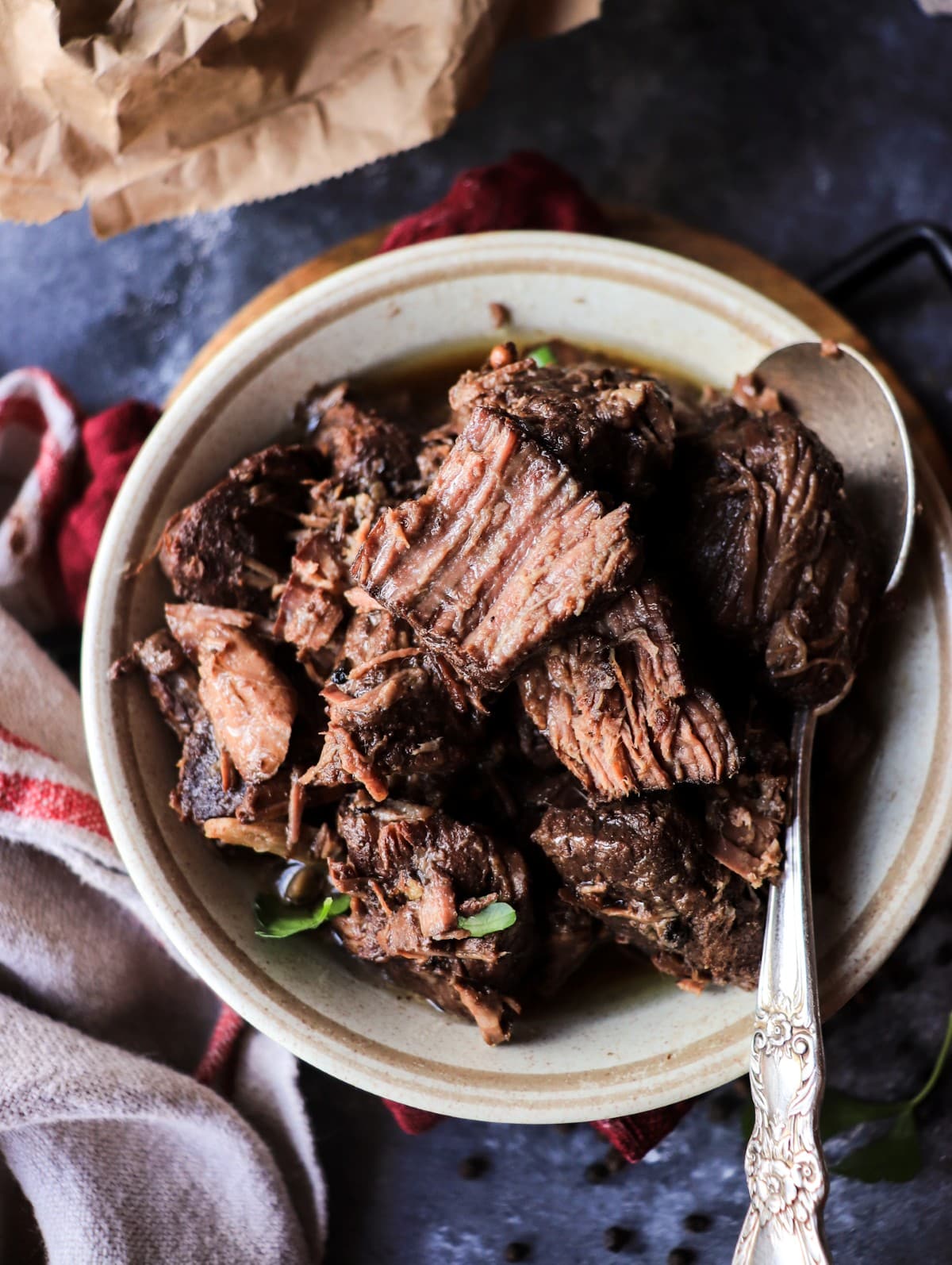 Tuscan Pepper Beef Stew (Peposo) served in a rustic bowl with stacked tender beef and dark red wine reduction.