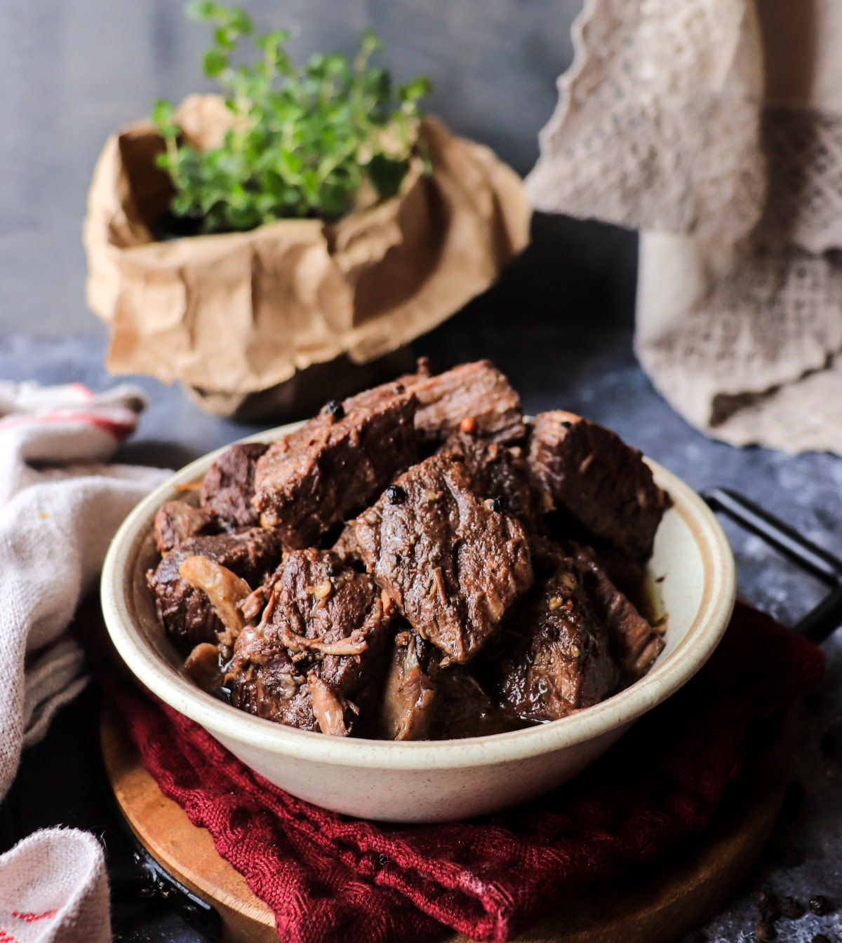 Tuscan Pepper Beef Stew (Peposo) served in a rustic bowl with stacked tender beef and dark red wine reduction.