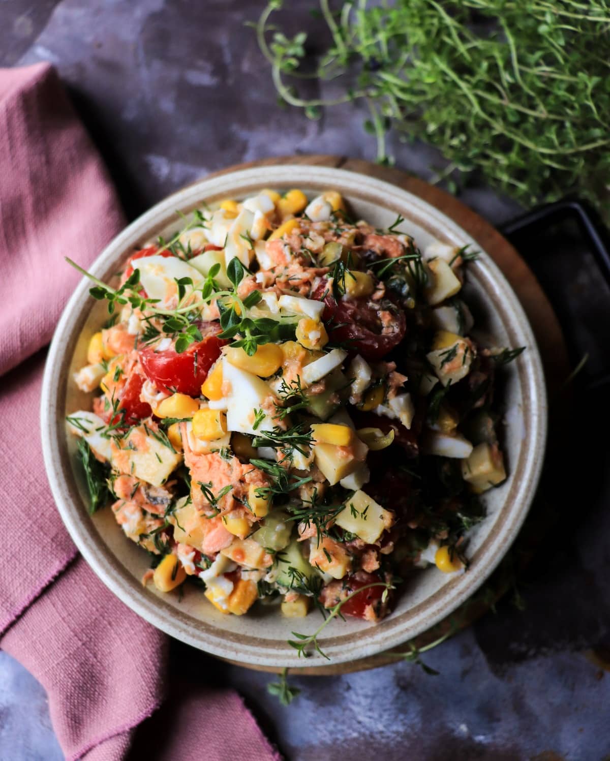 easy canned salmon salad with eggs, cucumber, and sweet corn close up