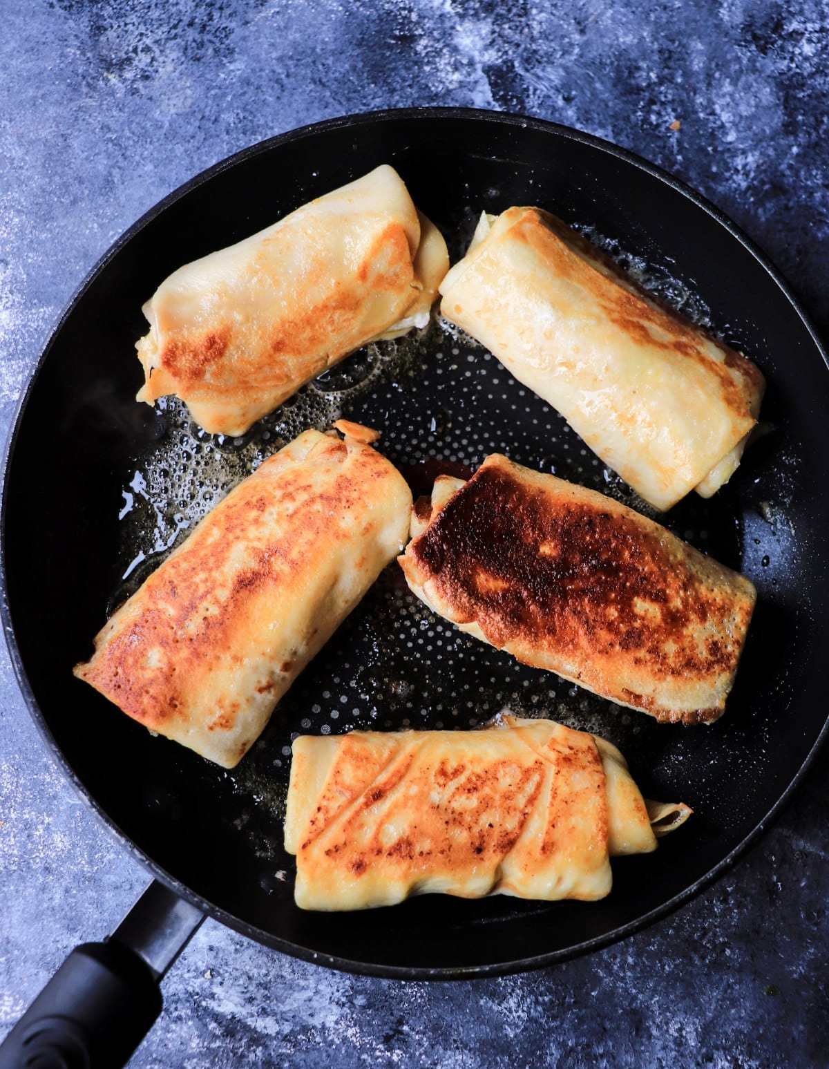 golden brown cottage cheese crepes in skillet