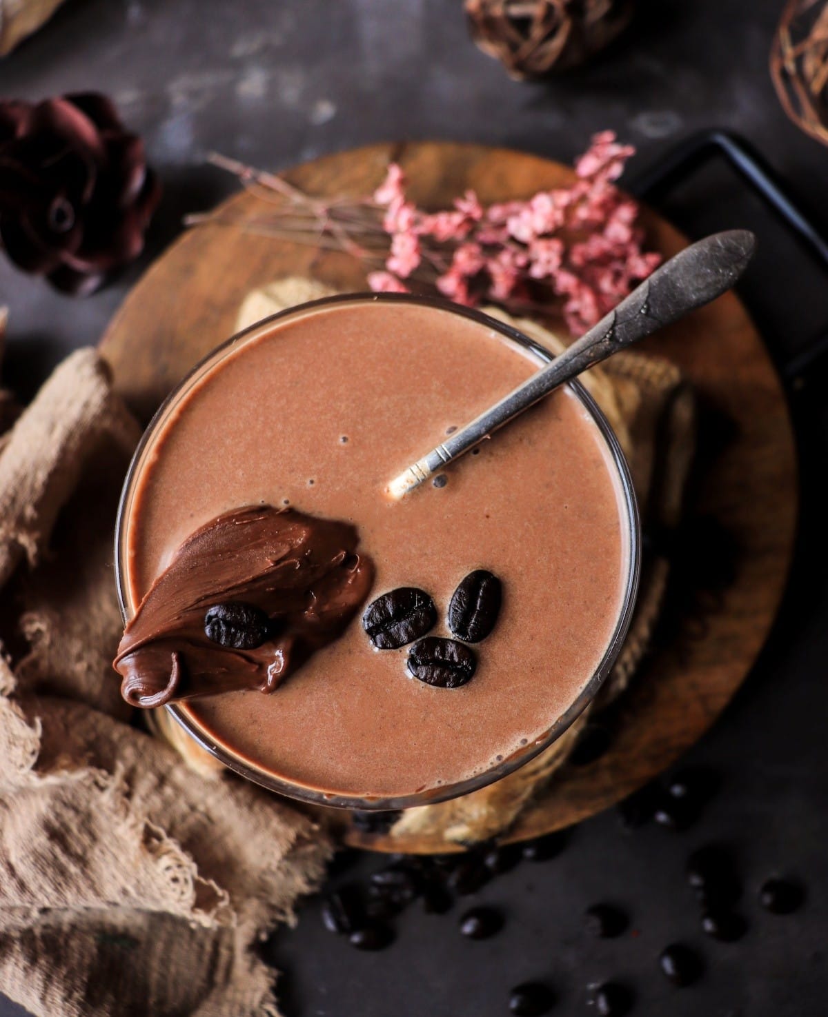Creamy chocolate hazelnut cocktail with Nutella, dark rum, and coffee liqueur, photographed from above.