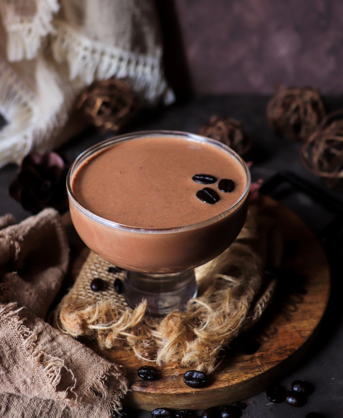 Creamy Nutella rum cocktail served in a coupe glass with coffee bean garnish, rich and smooth dessert-style drink.