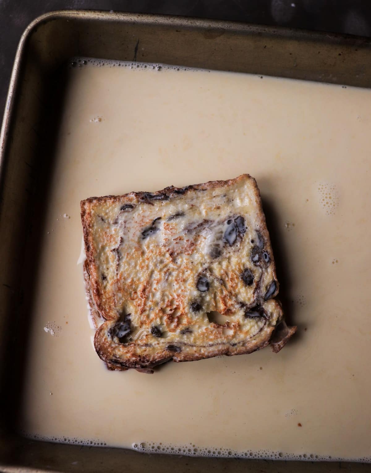 Soaking brioche bread in custard for stuffed French toast recipe