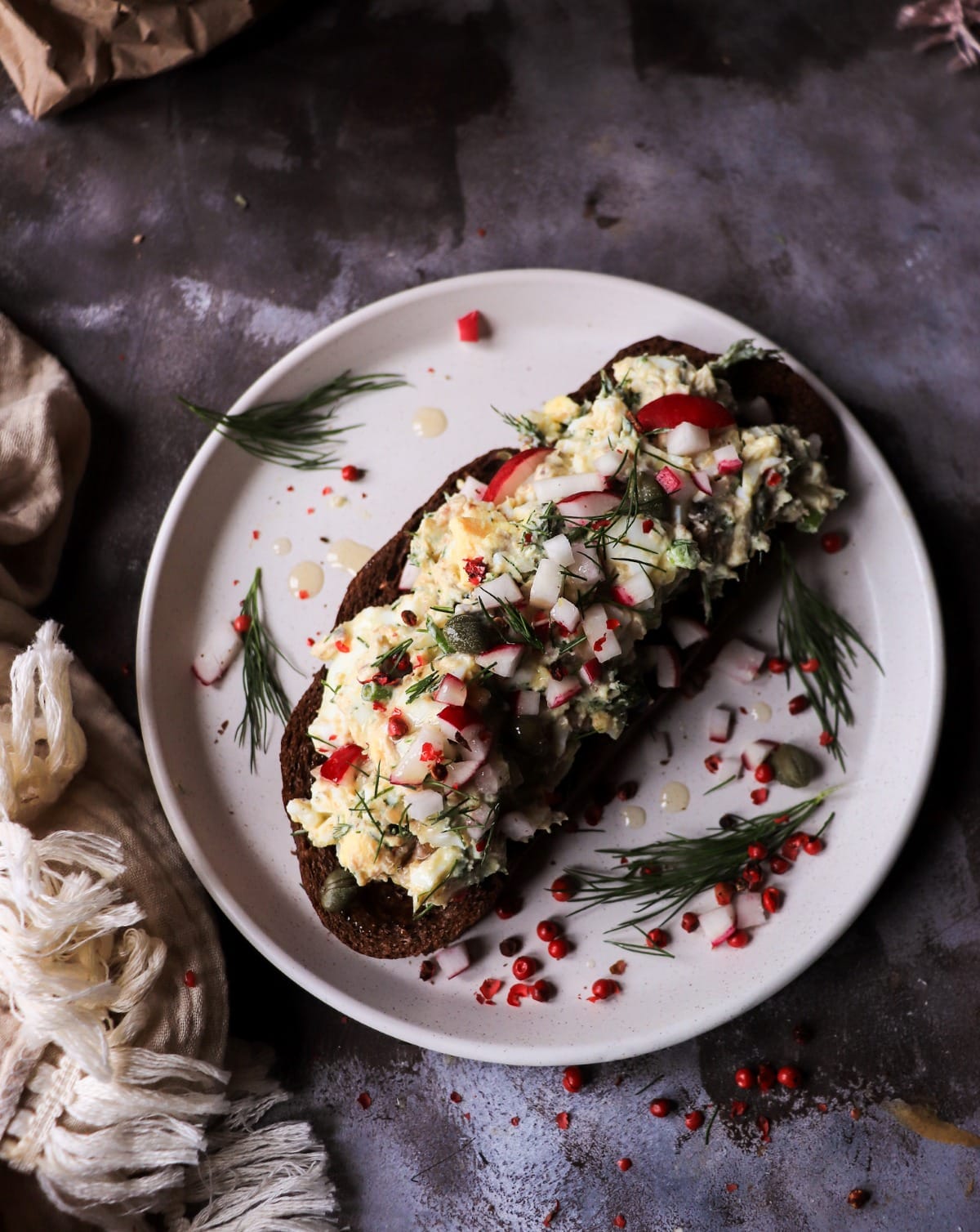egg salad with smoked sprats on rye open sandwich