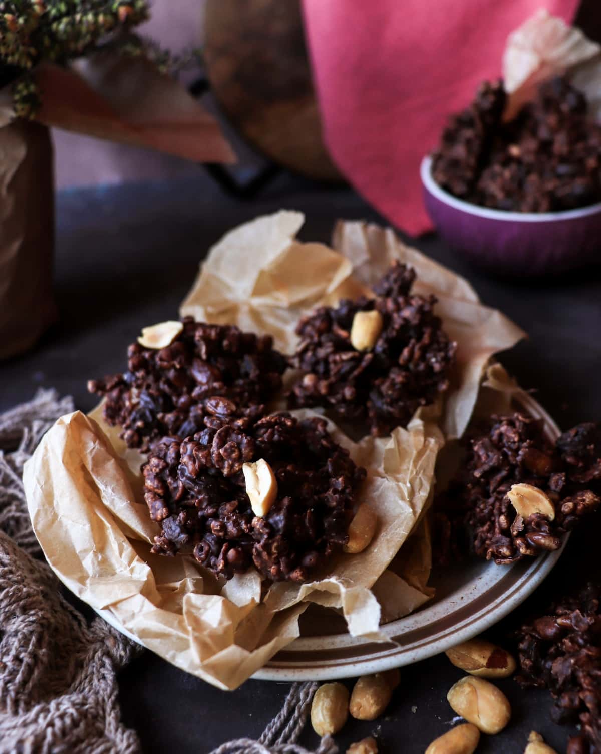 Close-up of dark chocolate espresso cornflake clusters showing crunchy cereal texture and toasted pine nuts.
