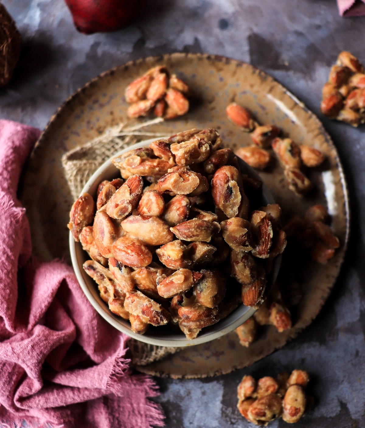 Homemade maple candied almonds with a matte sugar coating on a rustic plate