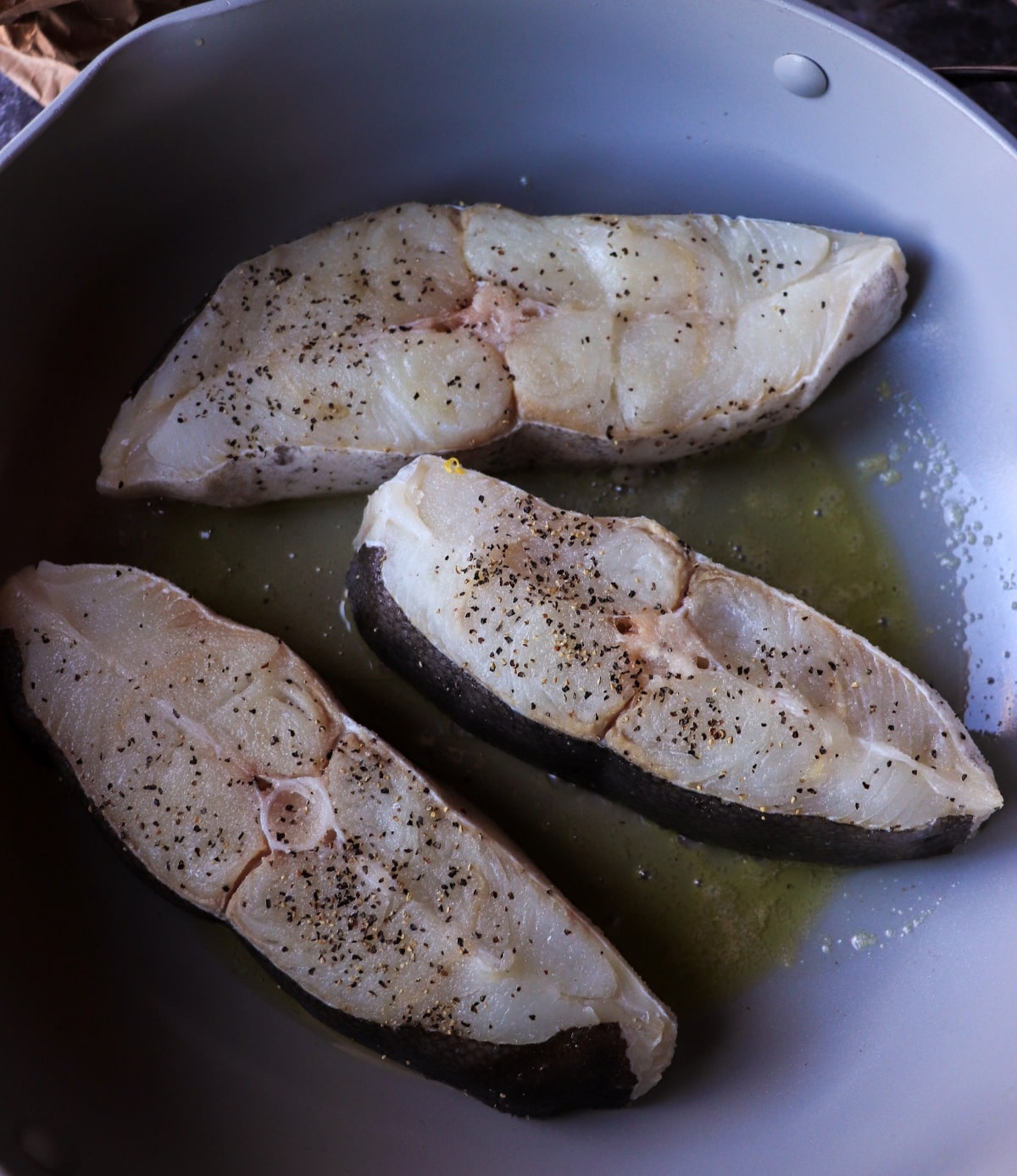 raw halibut steaks seasoned for cooking