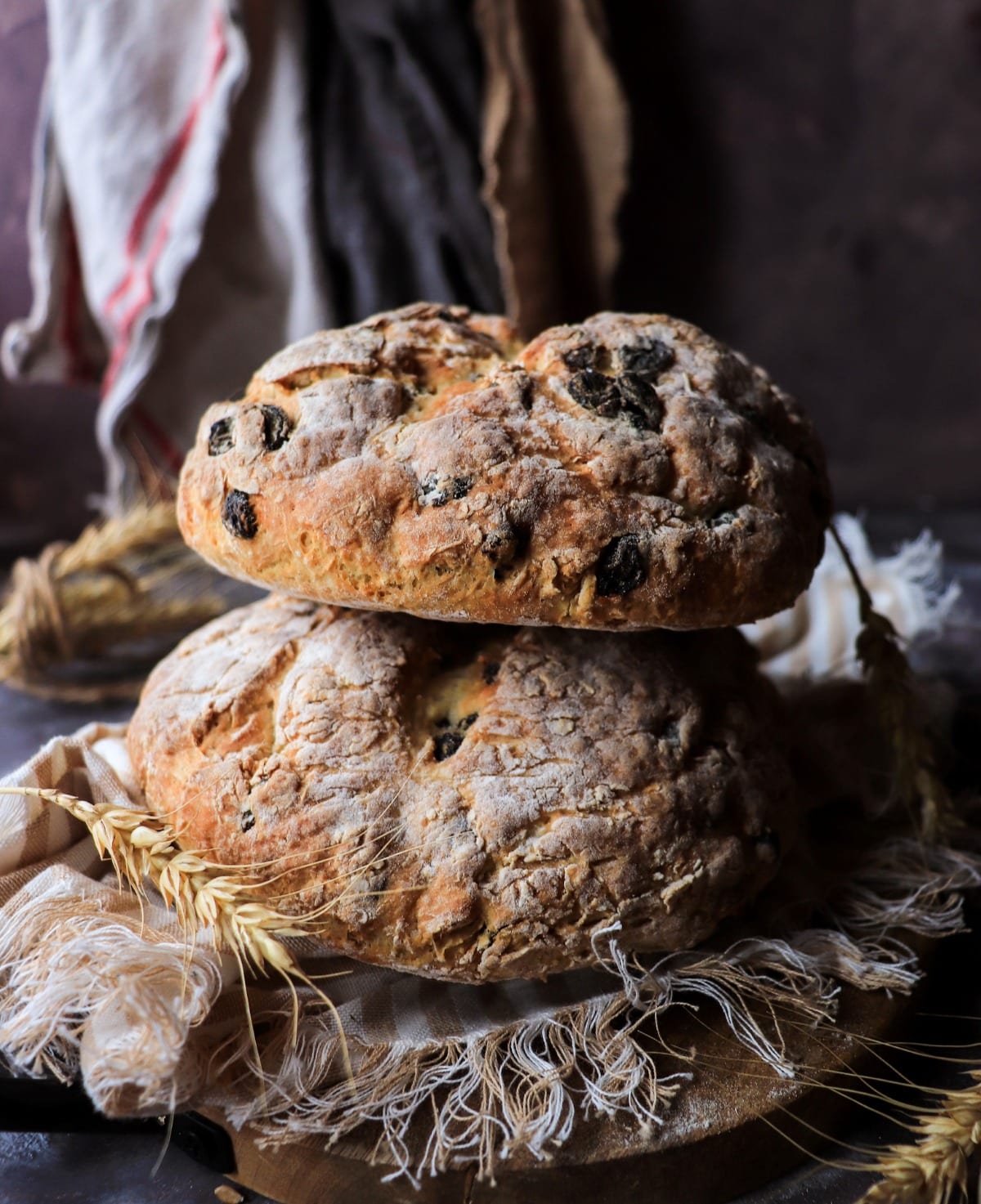 rustic homemade raisin soda bread loaves with wheat styling