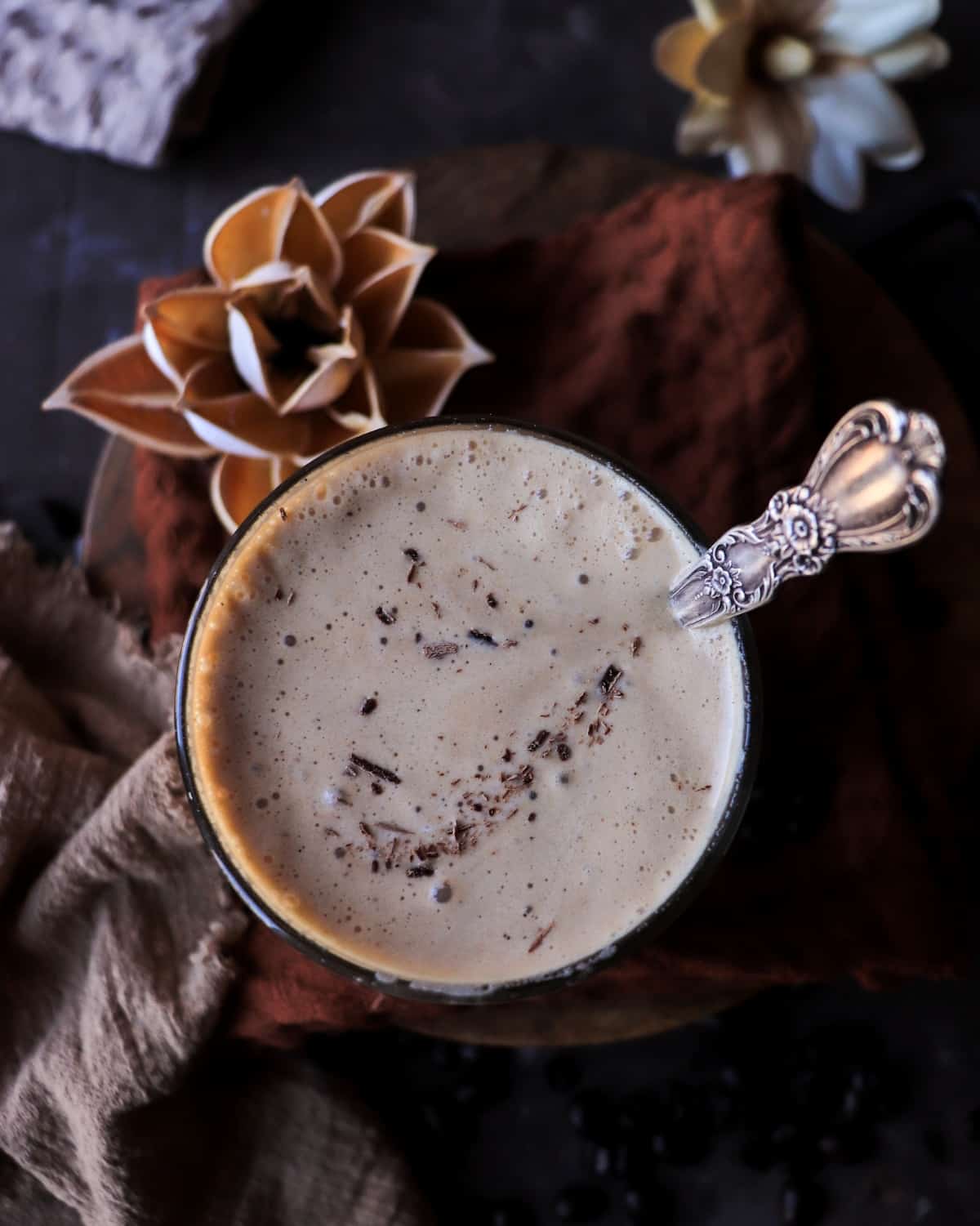 Adult milkshake recipe with coffee liqueur, shown from above with chocolate garnish and a spoon.