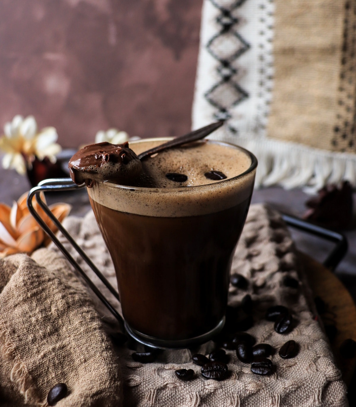 Nutella coffee with Kahlua and chocolate spread on a spoon, a rich and indulgent hazelnut coffee drink.