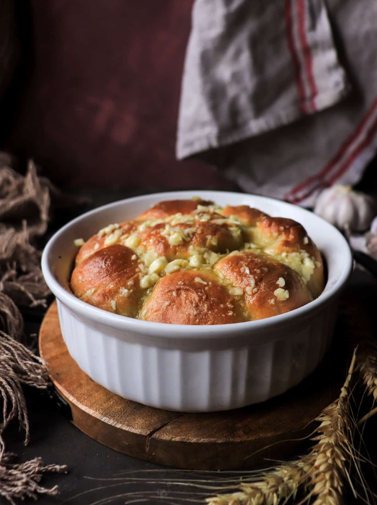 Pampushky, or Ukrainian garlic bread, baked until golden and topped with garlic and herbs.