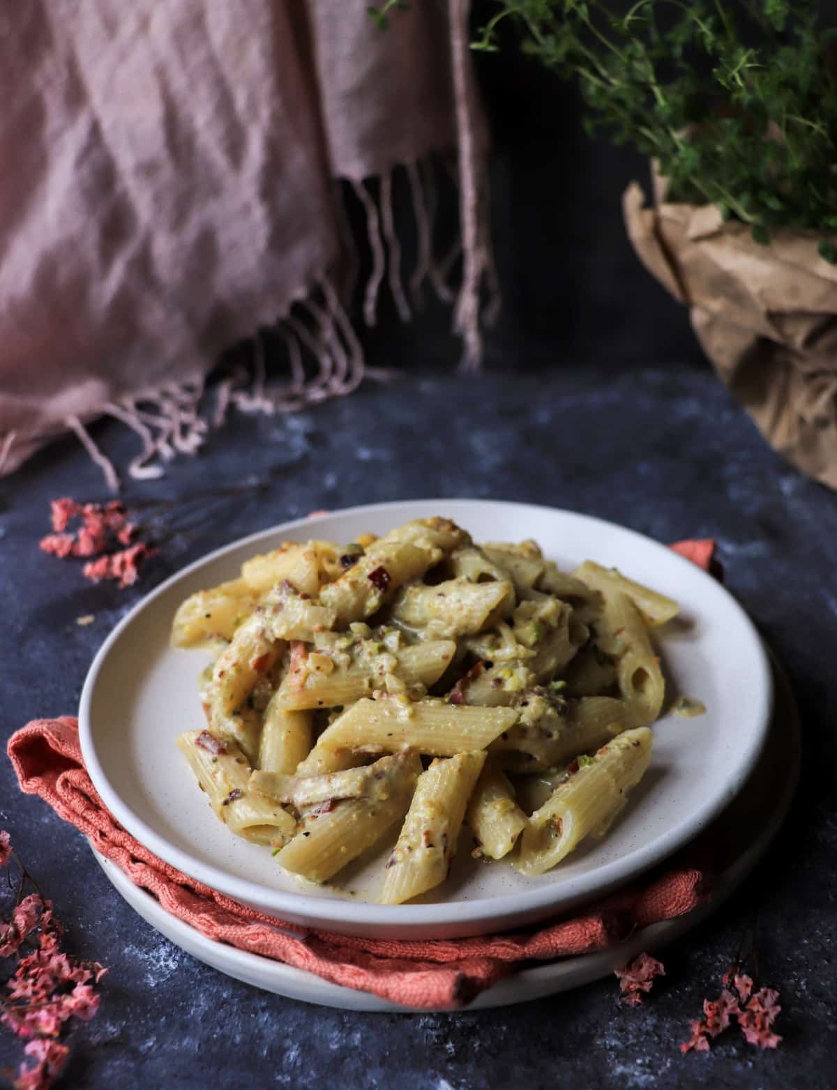 penne pasta with pistachio cream sauce and crispy speck close up