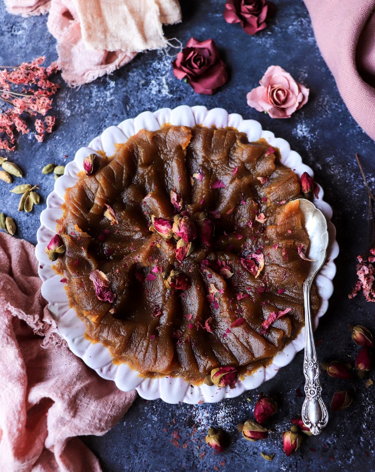 serving Persian halva with a spoon showing soft, smooth flour halva dessert texture