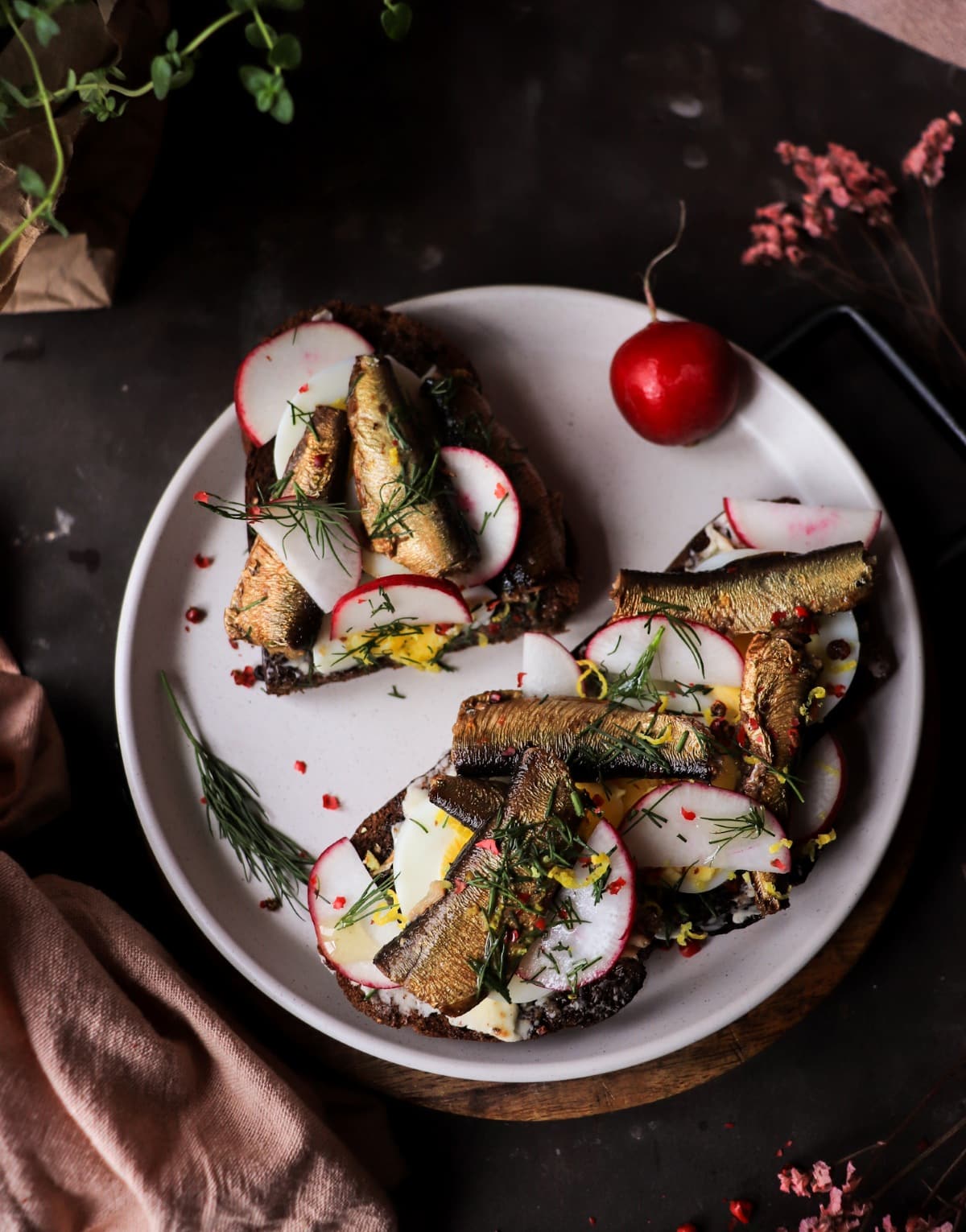 Baltic sprats on rye open sandwich with egg