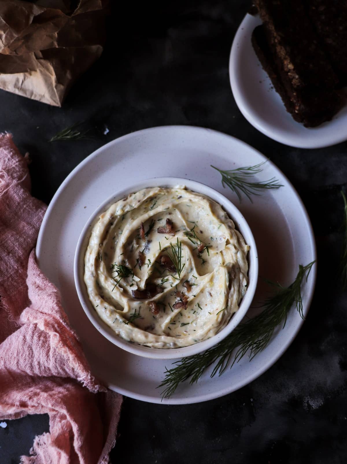 Anchovy compound butter in a bowl with dill and lemon zest