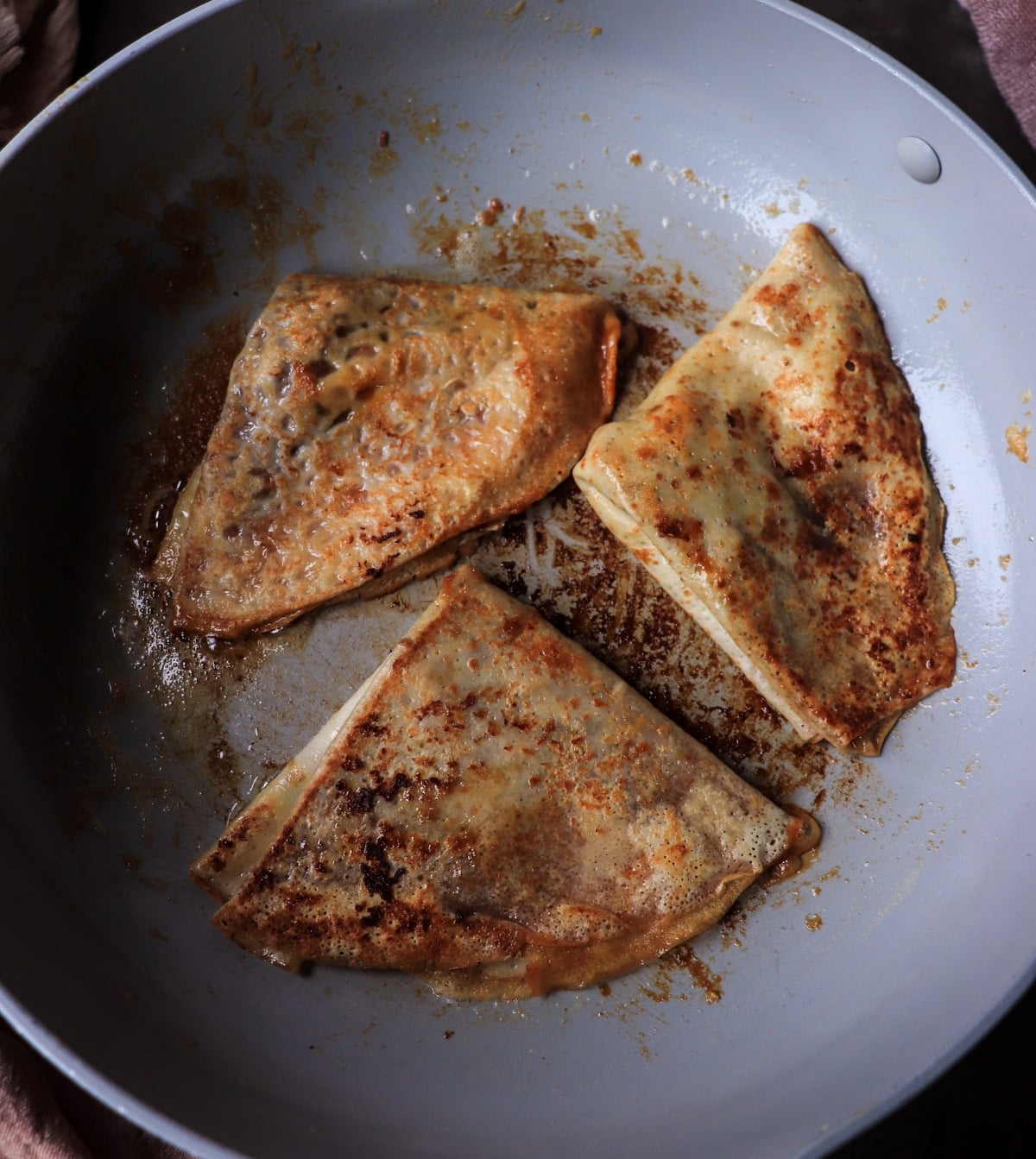 caramelized crêpes in pan with browned butter and dulce de leche sauce